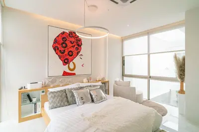 a bedroom with a bed with a red heart painting on the wall at The Residence Tropical 3BR Villa with Private Pool in Ban Pak Lak