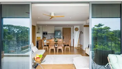 a living room and dining room with sliding glass doors at Beachside Residence 4 floor, Seaside, 250m to the beach in Bang Tao Beach