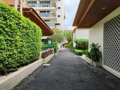 a walkway in front of a building with plants at 8 Floor - Mountain view Studio room at TBHR near Kata beach in Kata Beach