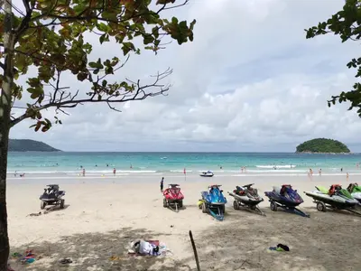a group of people sitting in chairs on a beach at 8 Floor - Mountain view Studio room at TBHR near Kata beach in Kata Beach
