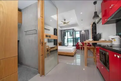 a room with a kitchen and a bedroom with a bed at Relife 5 mins walk to the beach in Rawai Beach