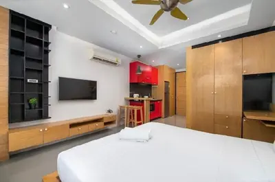 a bedroom with a white bed and a ceiling fan at Relife 5 mins walk to the beach in Rawai Beach