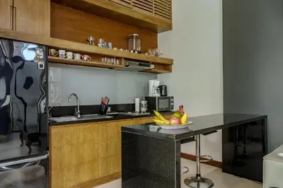 a kitchen with a counter with a bowl of fruit on it at Wings Elegant 2BR Villa Bang Tao Beach in Laguna Phuket