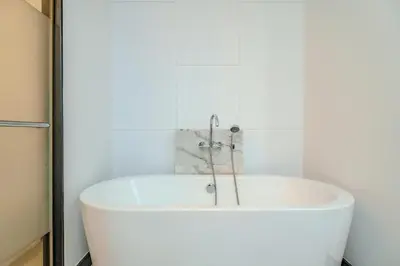 a white bath tub in a white bathroom at Wings Elegant 2BR Villa Bang Tao Beach in Laguna Phuket