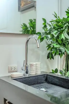 a kitchen counter with a sink and a plant at Wings Elegant 2BR Villa Bang Tao Beach in Laguna Phuket