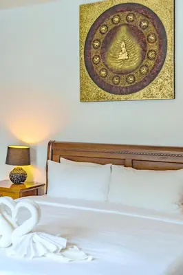 a bedroom with a bed with a picture on the wall at Wings Elegant 2BR Villa Bang Tao Beach in Laguna Phuket