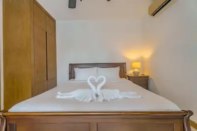 a bed with a white swan decoration on it at Wings Elegant 2BR Villa Bang Tao Beach in Laguna Phuket