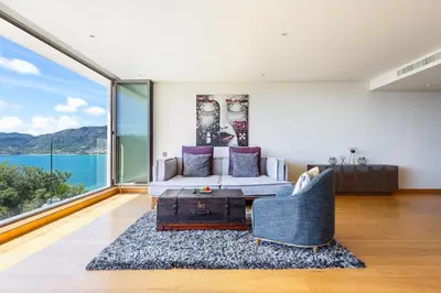 a living room with a couch and a table at Ocean View 3BR Apartment with Rooftop Terrace, Sapphire Bay 8-19 Residence in Patong Beach