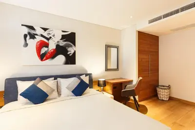 a bedroom with a bed and a desk in a room at Ocean View 3BR Apartment with Rooftop Terrace, Sapphire Bay 8-19 Residence in Patong Beach