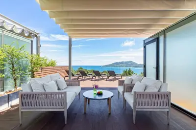 a living room with white furniture and a view of the ocean at Ocean View 3BR Apartment with Rooftop Terrace, Sapphire Bay 8-19 Residence in Patong Beach