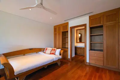 a bedroom with a bed and a ceiling fan at 4BR Lakeshore Pool Villa in Laguna Bangtao in Bang Tao Beach