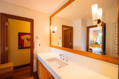 a bathroom with a sink and a large mirror at 4BR Lakeshore Pool Villa in Laguna Bangtao in Bang Tao Beach