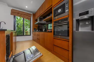 a kitchen with a sink and a microwave at Villa Fam with Private Pool Near Nai Harn Beach in Rawai Beach