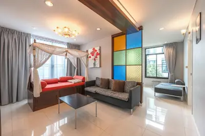 a living room with a couch and a table at C205 4BR Pool, Mountain Views & Prime Location in Kamala Beach