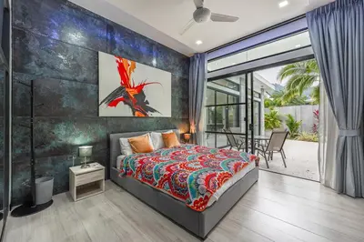 a bedroom with a bed and a large window at V204 Tropical Score 3BR with Pool, Tub & Snooker in Rawai Beach