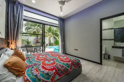 a bedroom with a bed and a view of a pool at V204 Tropical Score 3BR with Pool, Tub & Snooker in Rawai Beach