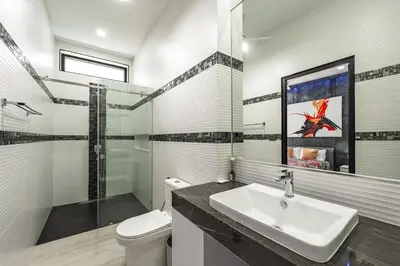 a bathroom with a sink and a toilet and a shower at V204 Tropical Score 3BR with Pool, Tub & Snooker in Rawai Beach