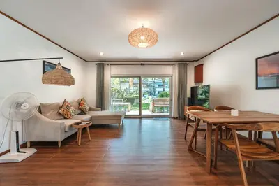 a living room with a couch and a table at V205 Island Hideaway Near Promthep Sunset in Nai Harn Beach