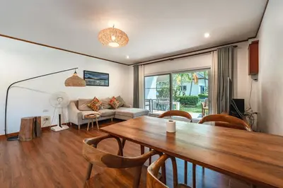 a living room with a table and a couch at V205 Island Hideaway Near Promthep Sunset in Nai Harn Beach