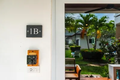 a door to a house with a sign on it at V205 Island Hideaway Near Promthep Sunset in Nai Harn Beach