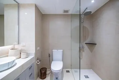 a bathroom with a toilet and a glass shower at JSD Prime Property-Cherngtalay in Laguna Phuket