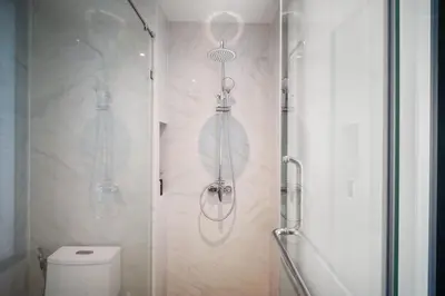 a bathroom with a shower and a toilet at Pool View 1310 Wyndham Condo in Nai Thon Beach
