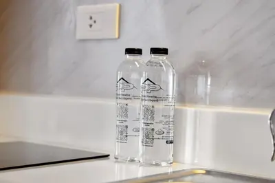 two bottles of water sitting on top of a sink at Pool View 1310 Wyndham Condo in Nai Thon Beach