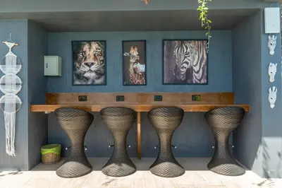 a table in a room with pictures on the wall at Calipso Garden 312 in Rawai Beach