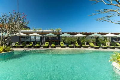 a pool with chairs and umbrellas in a resort at Calipso Garden 312 in Rawai Beach