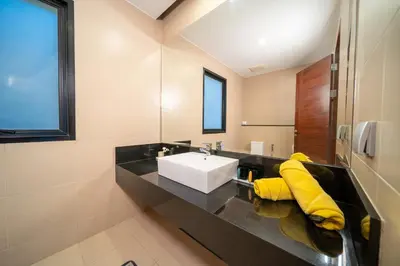 a bathroom with a sink and a mirror at \u4e5d\u96c5\u96c6 The Nine Refined Retreats in Rawai Beach