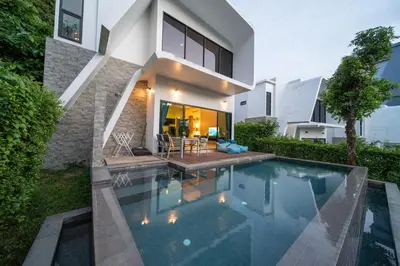 a swimming pool in the backyard of a house at \u4e5d\u96c5\u96c6 The Nine Refined Retreats in Rawai Beach