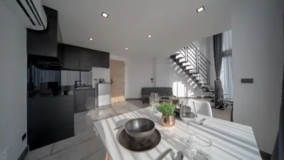 a kitchen and living room with a table and chairs at \u4e5d\u96c5\u96c6 The Nine Refined Retreats in Rawai Beach