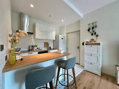 a kitchen with a counter with two chairs and a counter top at JU3 Halo NEW ВатСaп66935B2I976 in Nai Yang Beach