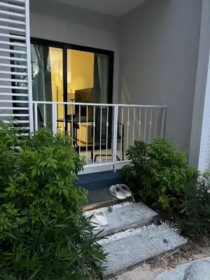a balcony of a house with a table and chairs at JU3 Halo NEW ВатСaп66935B2I976 in Nai Yang Beach