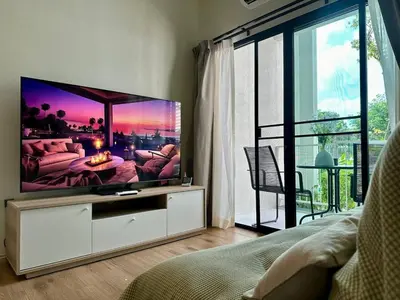 a living room with a flat screen tv in a room at JU3 Halo NEW ВатСaп66935B2I976 in Nai Yang Beach