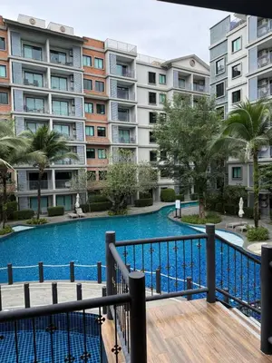 a view of the pool from the balcony of a apartment building at The title Naiyang - Beach Condos in Nai Yang Beach