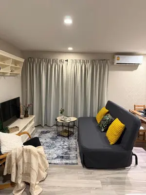 a living room with a couch and a table at The title Naiyang - Beach Condos in Nai Yang Beach