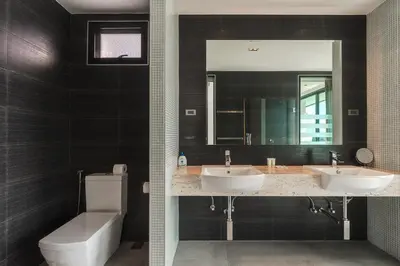 a bathroom with two sinks and a toilet and a mirror at V203 Seahorse Villa Stunning 4BR Oceanview Retreat in Bang Tao Beach