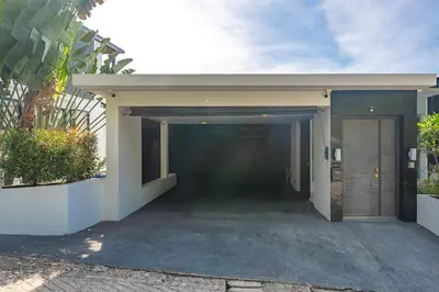 a building with a parking lot with a garage at V203 Seahorse Villa Stunning 4BR Oceanview Retreat in Bang Tao Beach
