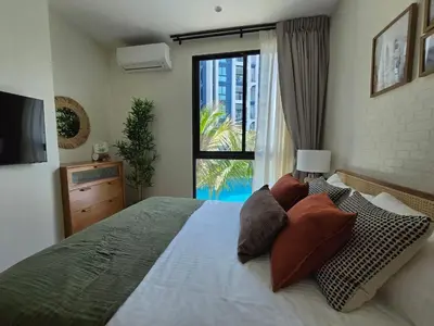 a bedroom with a large bed and a window at TheTitleHalo1 in Phuket