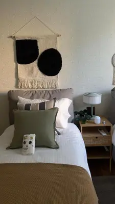 a bedroom with a bed with a clock on it at TheTitleHalo1 in Phuket