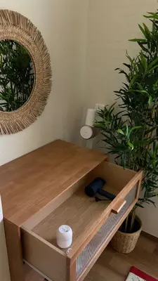 a wooden desk with a mirror and two plants at TheTitleHalo1 in Phuket