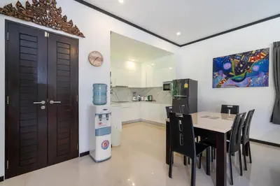 a kitchen and dining room with a table and chairs at Villa Prima - 3 Bedroom Private Pool Villa in Rawai Beach