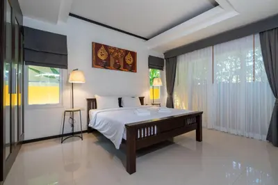 a bedroom with a bed and a large window at Villa Prima - 3 Bedroom Private Pool Villa in Rawai Beach