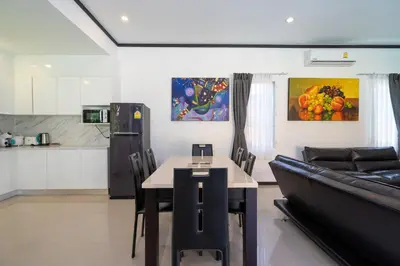 a living room with a table and a couch at Villa Prima - 3 Bedroom Private Pool Villa in Rawai Beach