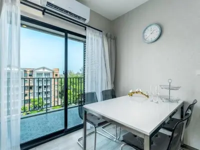 a dining room with a table and a clock on the wall at А4 Title 2-bedroom 86м2 ВатСaп66935B2I976 in Nai Yang Beach