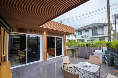 an outdoor patio with a table and chairs at DreamHouse in Ban Bang Khu