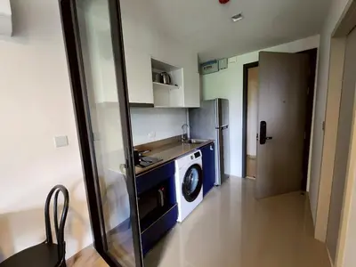 a small kitchen with a washer and dryer in it at The Base Central Phuket-B32YJ in Ban Rangeng