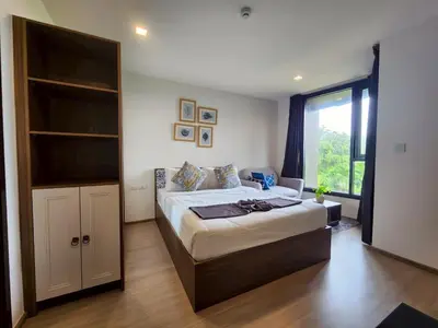 a bedroom with a large bed and a large window at The Base Central Phuket-B32YJ in Ban Rangeng
