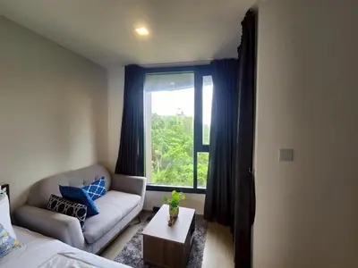 a living room with a couch and a window at The Base Central Phuket-B32YJ in Ban Rangeng